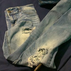 Light in color ripped jeans the rips go into the upper thighs